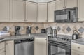 Your fully equipped kitchen features modern appliances and elegant tile backsplash, perfect for preparing meals during your stay.