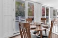 Your elegant dining space opens to a private terrace where morning coffee tastes better and evening meals feel special.
