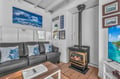 Cozy up by your private fireplace in this charming cottage living room, complete with ocean-themed artwork.