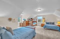 Your spacious family bedroom features comfortable beds and bunk beds, perfect for gathering everyone together under the cozy slanted ceiling.