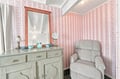 Your private retreat features a cozy armchair and vintage dresser, perfect for quiet moments. Soft lighting and thoughtful touches create a warm, welcoming space just for you.