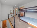 Rest comfortably in your private bunk bed space, featuring cozy blue bedding and modern touches in this thoughtfully designed sleeping area.