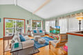 Sink into plush sofas surrounded by calming mint walls and natural light streaming through your private balcony doors.