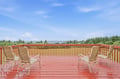 Expansive deck overlooking forested landscapes and distant ocean views. A peaceful retreat where you can relax in comfortable seating and breathe in the fresh coastal air.