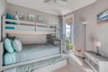 Your kids will love this cheerful bunk room with soft coastal colors and plenty of space to play and relax together.