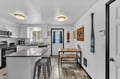 Your fully equipped kitchen features modern appliances, sleek countertops, and a breakfast bar where you can enjoy morning coffee before exploring the mountains nearby.