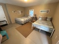 Unwind in your cozy twin bedroom with comfortable beds, charming nautical decor, and a peaceful atmosphere perfect for restful nights.