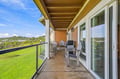 Step out onto your private balcony, where Adirondack chairs frame sweeping views of lush greenery and open skies—a serene spot to sip morning coffee or unwind as the day fades.