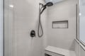 Step into your private spa retreat with this sleek walk-in shower featuring dual rainfall heads and modern stone tiles for ultimate relaxation.