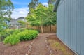 Quiet residential setting surrounded by lush greenery and neighboring homes, offering a peaceful retreat in a friendly neighborhood.