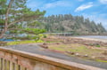Coastal property nestled among towering evergreens with direct beach access and scenic forested hillsides creating a peaceful Pacific Northwest retreat.