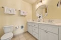 Freshen up in your private bathroom, featuring a spacious dual-sink vanity, plush towels, and thoughtful touches to make your stay comfortable and convenient.