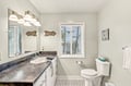 Your coastal-themed bathroom blends function and charm, with beachy décor, crisp white cabinetry, and natural light that sets a calm, refreshing tone.
