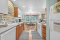 Step into your fully equipped kitchen with warm wood cabinets, modern appliances, and a sunny breakfast nook where you'll enjoy morning coffee.