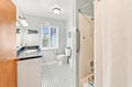 Freshen up in your private bathroom with classic black-and-white tiled floors and a soothing coastal vibe. The shower-tub combo and natural light make every morning feel like a mini-retreat.