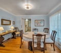 Gather around the elegant dining table for memorable meals in this charming space, where classic furnishings and soft lighting create a warm, inviting atmosphere for your stay.