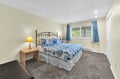 Unwind in your serene bedroom with coastal-inspired blue linens and warm lamplight creating the perfect retreat for restful nights.