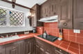 Your fully equipped kitchen features charming exposed beams and terra cotta tiles, perfect for preparing meals during your stay.