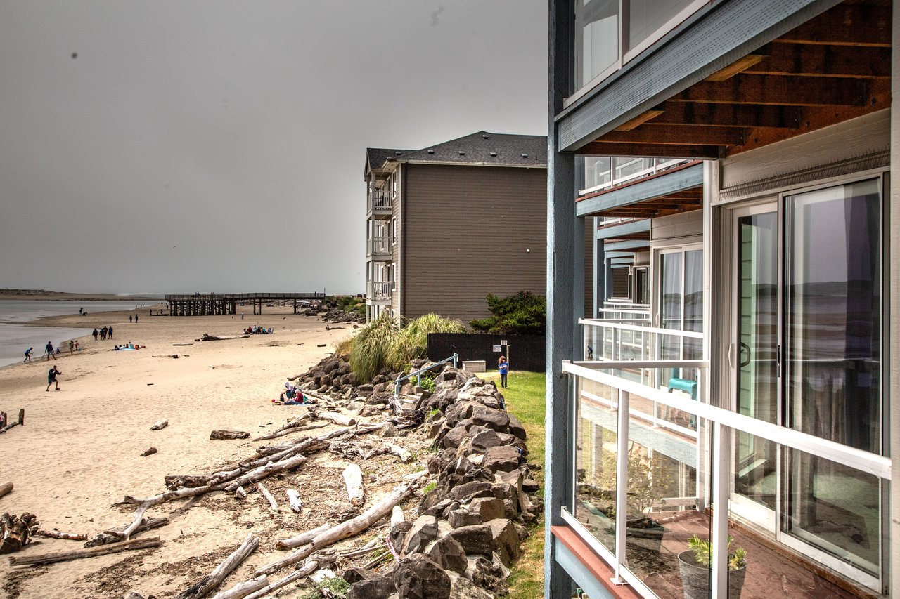 Beachfront property located along sandy shores with direct coastal access and scenic driftwood-lined pathways leading to the waterfront.