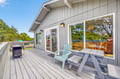 Your private deck features comfortable seating and BBQ facilities, perfect for morning coffee or evening grilling while enjoying peaceful garden views.