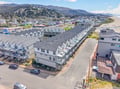 Coastal rental property nestled between forested hills and sandy beach in a charming seaside community.
