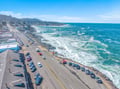 Stunning aerial view of the scenic coastal town with dramatic oceanfront and mountain backdrop near the property.
