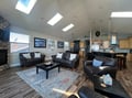 Sink into plush leather seating beneath skylights that flood your open-concept retreat with natural warmth. Your coastal-themed great room flows seamlessly into a fully equipped kitchen, perfect for easy entertaining.