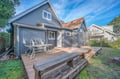 Charming coastal cottage with spacious deck for morning coffee and evening relaxation in peaceful neighborhood setting.