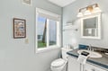 Freshen up in your bright, thoughtfully designed bathroom, where natural light streams in and everything you need is just a reach away.