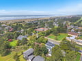 Stunning coastal community with oceanfront access, sandy beach stretching for miles, and tree-lined residential neighborhood just steps from the shore.