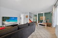Unwind in your spacious living room with plush seating and large TV for cozy movie nights together.