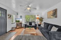 Unwind in your spacious living room with plush seating, natural light, and a ceiling fan to keep you comfortable year-round. The warm wood floors and thoughtful décor create a welcoming retreat after a day of exploring.
