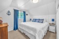 Your coastal retreat awaits with crisp white linens, nautical accents, and ocean blue touches creating the perfect seaside sanctuary.
