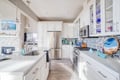 Your gourmet kitchen awaits with gleaming quartz counters, stainless appliances, and ocean-themed touches that inspire coastal cooking adventures.