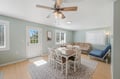 Step into your bright, open living and dining space where soft coastal hues and natural light create an instantly welcoming atmosphere for meals and relaxation.