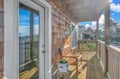 Step onto your private covered deck with coastal neighborhood views and wooden seating to savor morning coffee in the fresh air.