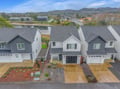 Modern townhomes nestled in a scenic mountain community with lake views and forested hills surrounding the peaceful neighborhood.