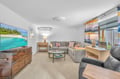 Sink into plush sectional seating while tropical scenes play on your large TV, creating the perfect movie night retreat.