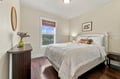 Drift off in this serene bedroom with soft linens and peaceful neighborhood views. The warm wood floors and thoughtful decor create a restful retreat after your adventures.