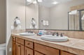 Your spacious double-sink vanity offers plenty of room to get ready, with warm wood cabinets and fresh towels waiting for you.