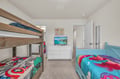 Your kids will love this cheerful room with bunk beds and colorful themes, plus their own TV for movie nights.