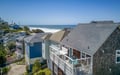 Elevated coastal property featuring ocean views, with nearby beach access and surrounding vacation homes creating a serene seaside retreat atmosphere.