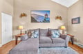 Sink into the plush sofa and admire the lighthouse artwork while warm lamps create the perfect ambiance for your coastal retreat.