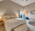 Your serene bedroom retreat features a plush bed dressed in soft linens, vaulted ceilings that create an airy feel, and a private balcony where mountain views await.