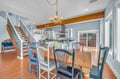 Gather around your spacious dining table where colorful mismatched chairs invite lively conversations over home-cooked meals from your fully equipped kitchen.