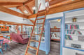 Climb up to your cozy loft retreat while kids enjoy the charming bunk bed nook below—this open-concept space blends rustic warmth with playful comfort.
