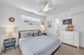Drift off in this serene coastal-themed bedroom where nautical touches and soft lighting create your peaceful retreat. The ceiling fan ensures you'll sleep comfortably, and your own ensuite bath awaits just steps away.