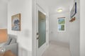 Step inside to discover bright, clean spaces with thoughtful coastal touches. Your well-stocked pantry awaits, while windows frame lovely greenery outside.