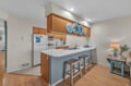 Your fully equipped kitchen features a breakfast bar perfect for morning coffee and quick meals, with modern appliances ready for your culinary adventures.