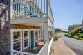 Coastal beach home featuring white-railed balconies and shingled exterior in a peaceful seaside neighborhood. Ocean views and nearby beach access make this an ideal coastal getaway.
